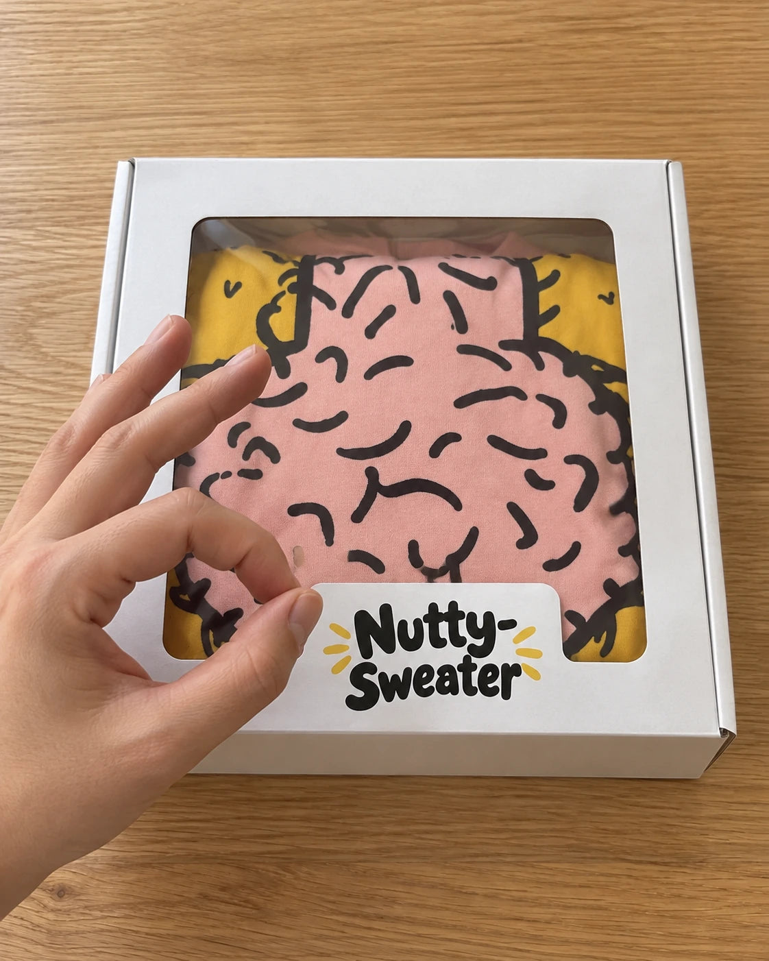Nutty Sweater folded inside a gift box
